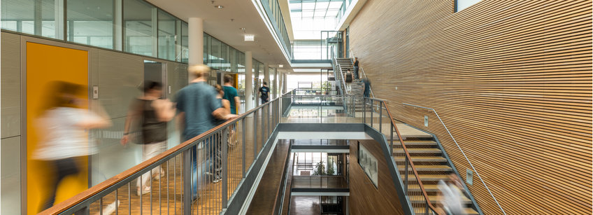 Blurry people walking in the corridors of the Max Planck Institute for Biology